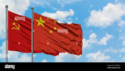 Soviet Union And China Flag Waving In The Wind Against White Cloudy