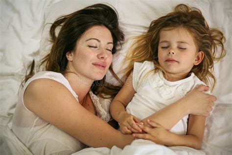 Mother And Daughter Sleeping Together In Bed Mother And Daughter