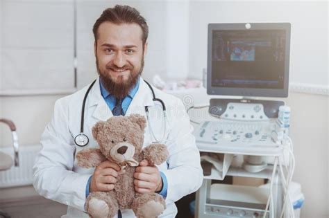 Friendly Male Pediatrician Working At The Clinic Stock Image Image Of