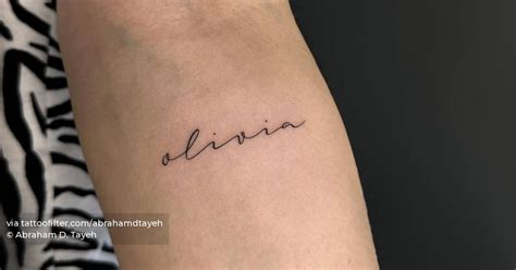 Tattoo Of The Name Olivia Handwritten On The Inner