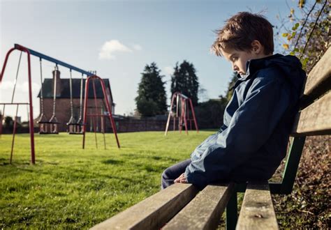 Lonely Child Sitting On Play Park Playground Bench Sensory Stepping