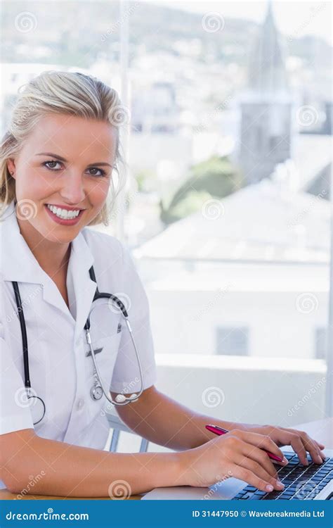 Smiling Nurse Working On Her Laptop Stock Photo Image Of Fair