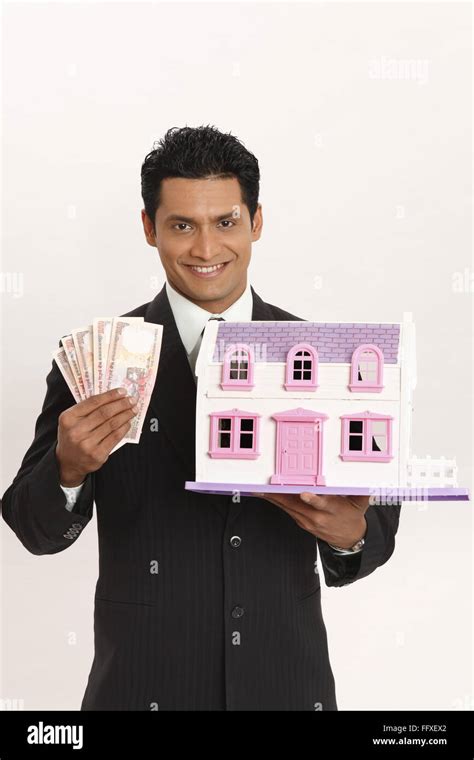 Businessman Holding House Model And Cash In Both Hands Mr703t Stock