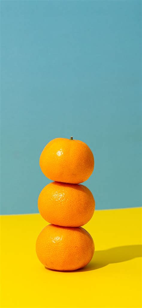 Orange Fruit On Yellow Surface Iphone 11 Wallpapers Free Download