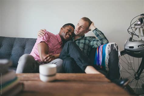 Portrait Of Young Interracial Gay Couple On A Couch By Stocksy Contributor Joselito Briones