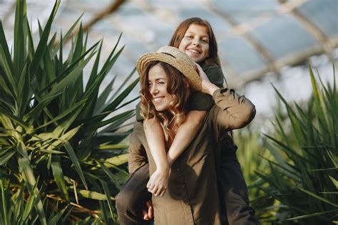 Mom Giving A Piggy Back Ride To Her Daughter · Free Stock Photo
