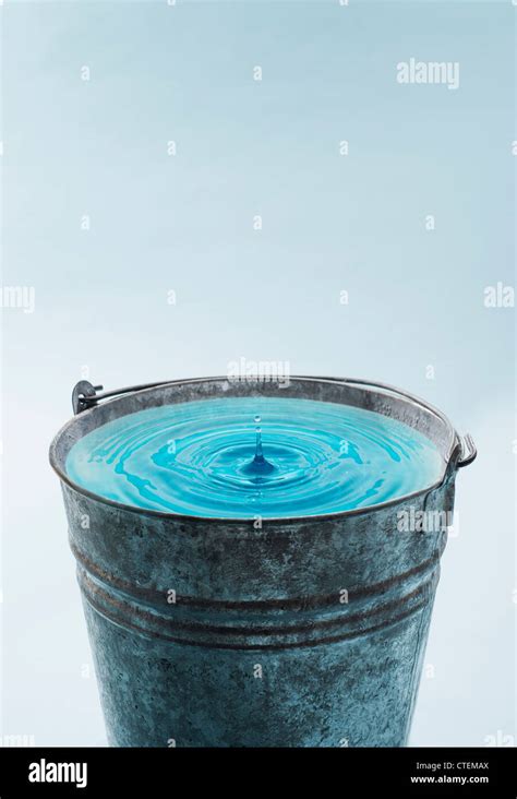 Drop Falling Into Water In Bucket Stock Photo Alamy