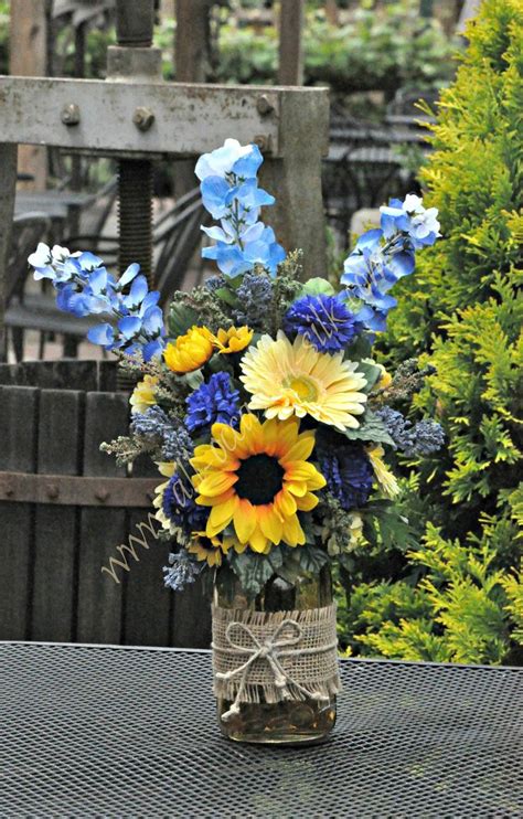 Rustic Style Centerpiece Featuring Sunflowers Blue Delphinium Blue