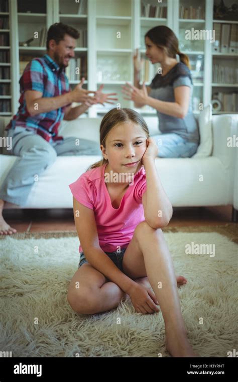 Sad Girl Listening To Her Parents Arguing Stock Photo Alamy