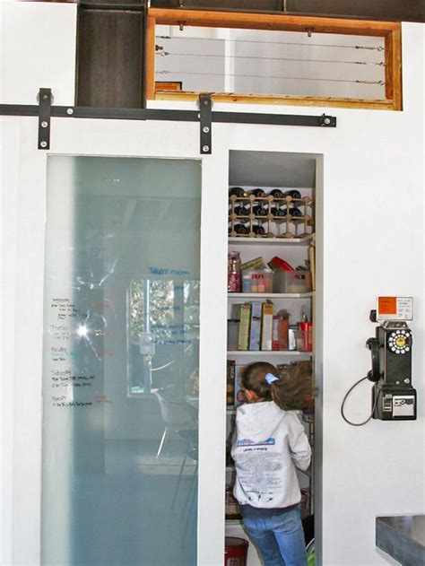 We have double and single door cabinets, as well as cabinets with drawers. Sliding glass barn door. Write the grocery list and family ...