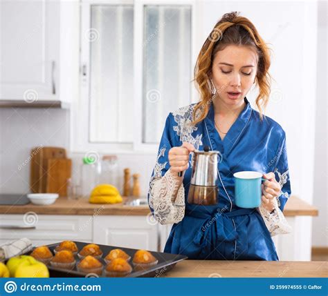 Upset Just Woken Up Woman In Blue Peignoir Preparing Coffee In Kitchen