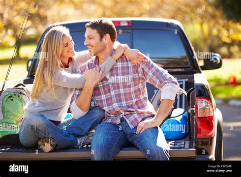 Couple Sitting In Pick Up Truck On Camping Holiday Stock Photo Alamy