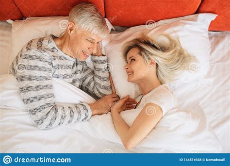 Mature Love Couple Looks At Each Other In Bedroom Stock Photo - Image of closeness, mature ...