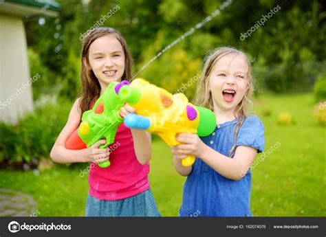Cute Children Playing With Water Guns ⬇ Stock Photo Image By