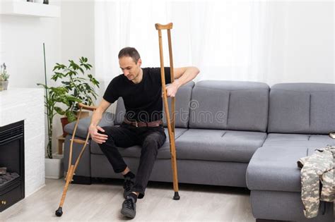 Disabled Man Using Crutches At Home Stock Photo Image Of Feet Front