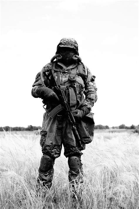 Solider In Mopp Gear With Suppressed Aks 74u Black And White