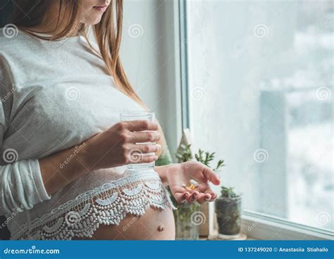 Conceptual Photo Of Pregnancy Healthcare Pregnant Woman Taking Pills