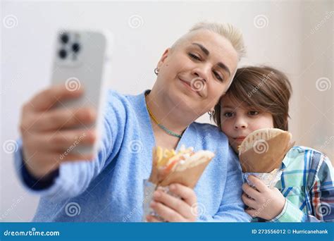 Mother And Son Taking A Selfie With Food White Woman With Short Hair