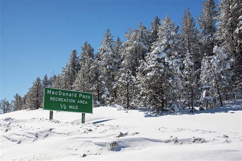 Macdonald Pass Sign In The Winter Time Photograph By Tatiana Travelways
