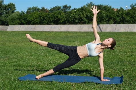 Young Slender Girl Doing Yoga On A Sunny Morning Plank Exercise