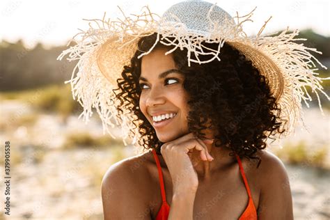 Positive Young African Woman Posing At The Beach Outside Stock Photo