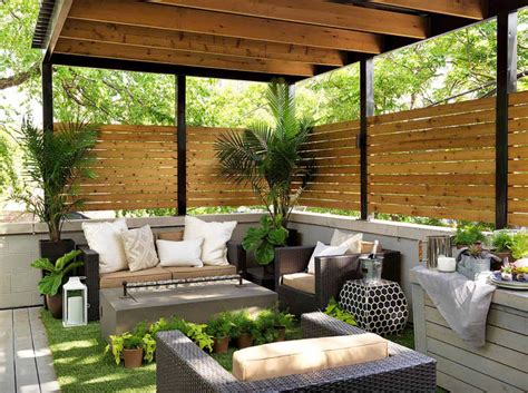 An Outdoor Living Area With Couches Tables And Potted Plants