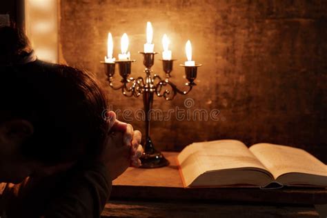 Senior Woman Praying Hands Clasped Together On Her Bible Stock Image