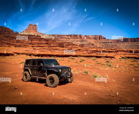 Epic View Of A Fast Jeep Wrangler In A Rocky Hot Desert In Moab Utah The United States Stock