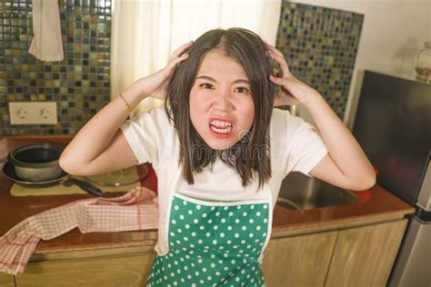 Young Tired And Stressed Asian Korean Woman In Cook Apron Working