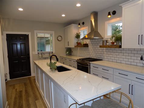 Beautiful White Kitchen This kitchen offers a clean white feel but the black door offers a 