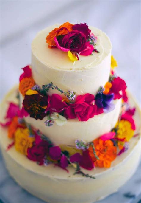 A white wedding cake with gold glitter and fresh greenery and blooms is a cool idea for a modern wedding. Hello May · WEDDING CAKE INSPIRATION