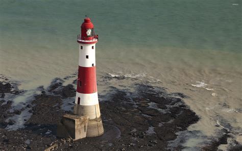 Red And White Lighthouse Surrounded By Water Wallpaper World