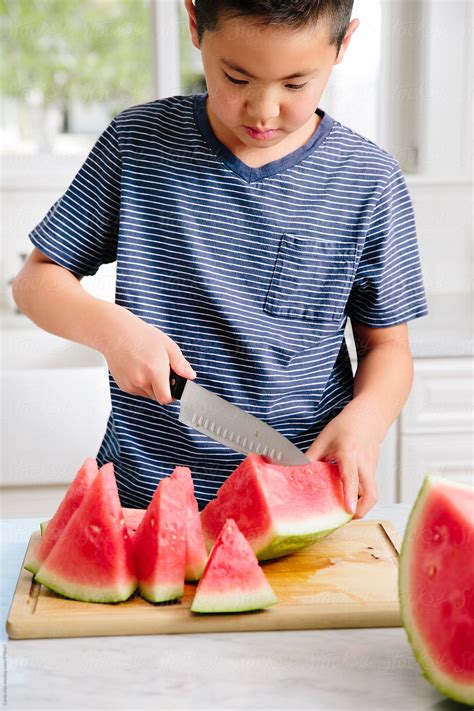 Asian Boy Cutting Watermelon By Stocksy Contributor Curtis Kim