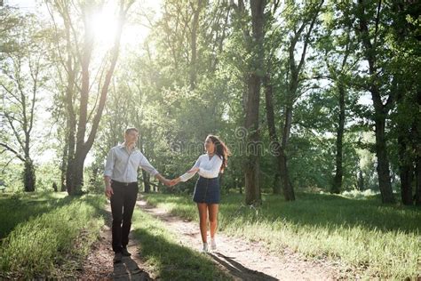 Young Couple Walking In The Forest Summer Nature Bright Sunlight
