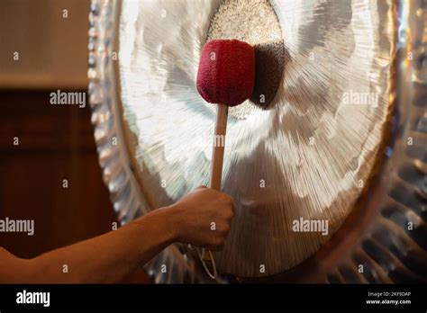 Man Playing Suspended Gong During Spiritual Practice Stock Photo Alamy