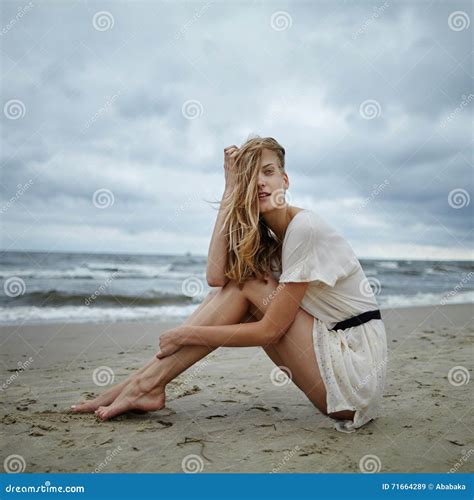 Young Beautiful Woman On Cold Windy Beach Stock Image Image Of Clouds