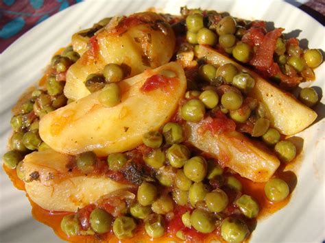 Potatoes And Peas In Tomato Sauce Cooking In Plain Greek