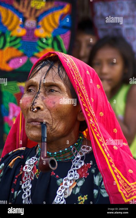 Femme indienne Kuna avec nez tattoo est fumant une pipe un collier fait à partir de la soude