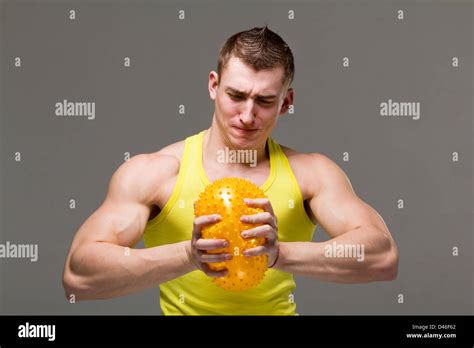 Muscular Young Man Flexing Arm Muscles Stock Photo Alamy