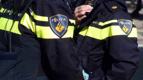dutch local police officers in police uniform standing on the street of the hague south holland