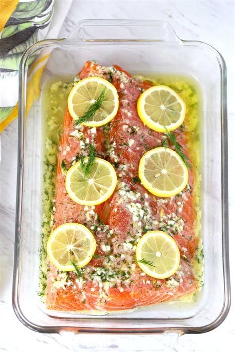 Salmon Seasoned With Flavored Butter And Topped With Lemon Slices