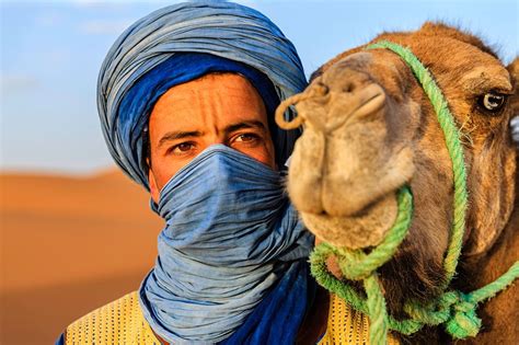 Tuareg With Camel On The Western Part Of The Sahara Desert In Morocco