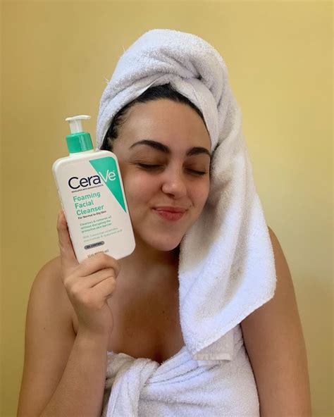 a girl holding a cerave facial cleanser and posing with it photography inspo aesthetic