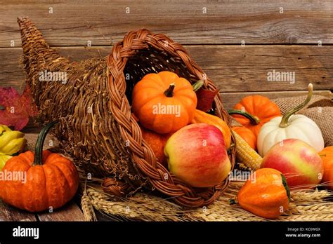 Thanksgiving Cornucopia Filled With Pumpkins And Fruit Against A Rustic