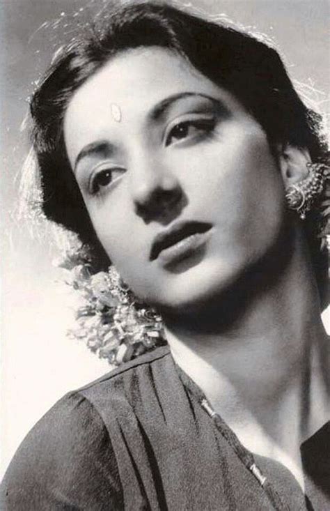 An Old Black And White Photo Of A Woman With Large Earrings On Her Head