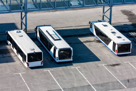 Airport Buses At The Parking Near Passenger Boarding Bridge Stock