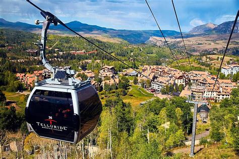 Ski Lift Gondola Ascending Mountain With Picturesque Village In The