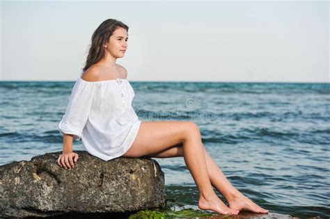 teen girl bikini slender pre teen girl smiles and squats barefoot in a bikini stock image