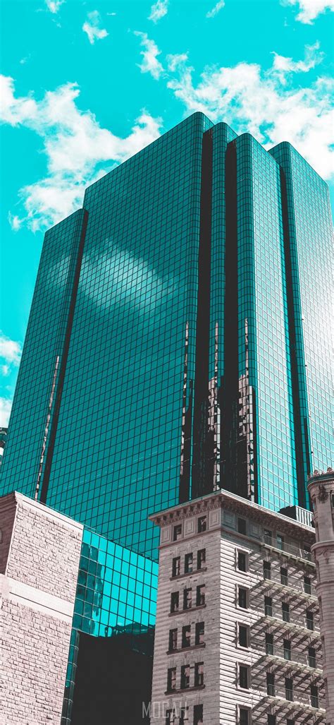 Turquoise Sky Frames A Reflective Downtown Office Building Windows In