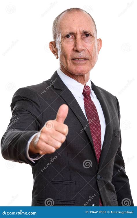 Studio Shot Of Senior Businessman Giving Thumb Up Stock Photo Image